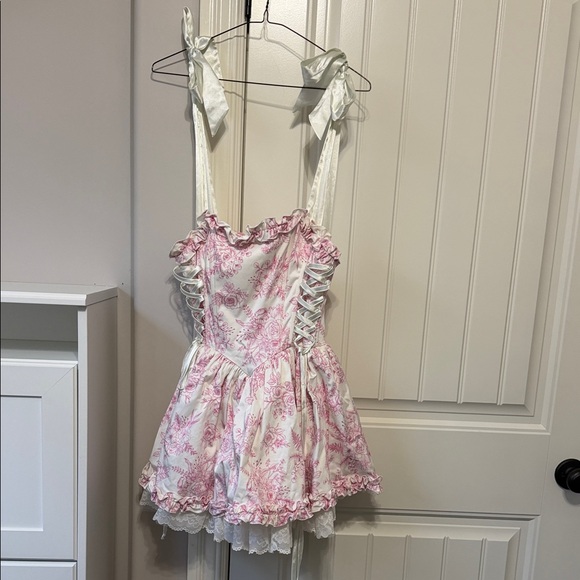 Dolls Kill Dresses & Skirts - Dolls Kill White and Pink Floral Ruffled Mini Dress with Lace-Up Sides
